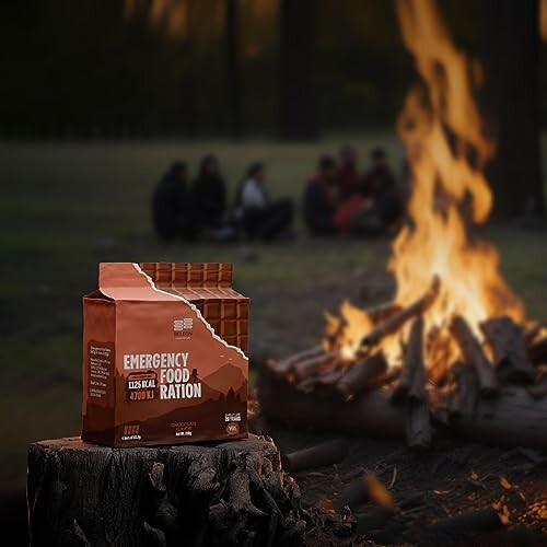 Emergency food ration pack near campfire with people in background.