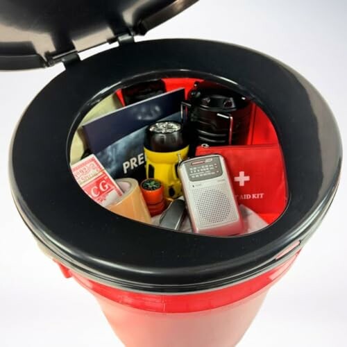 Open emergency preparedness kit with supplies like a radio, flashlight, first aid kit, and more.