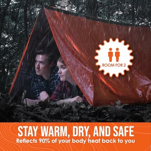 Two people under an orange emergency tent in the rain.