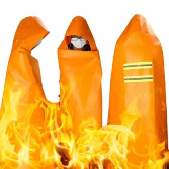 Individuals in orange fire protective suits with flames in foreground.