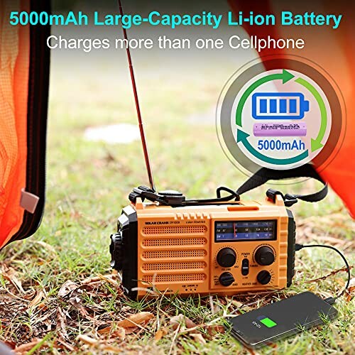 Portable radio with 5000mAh battery charging a smartphone outdoors.