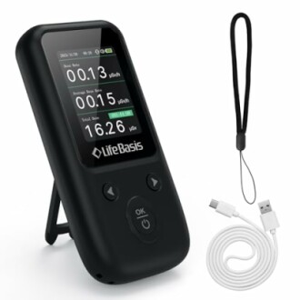 Portable radiation detector with display, strap, and USB cable.