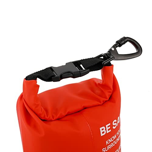 Red dry bag with black clip and safety message.