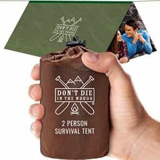 Hand holding a compact 2-person survival tent with 'Don't Die in the Woods' branding.