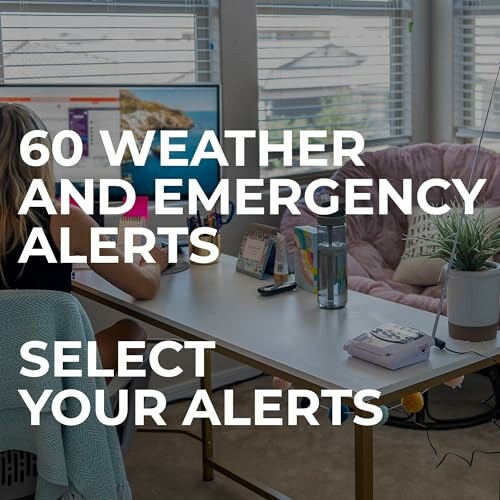 Person at desk setting weather and emergency alerts on computer.